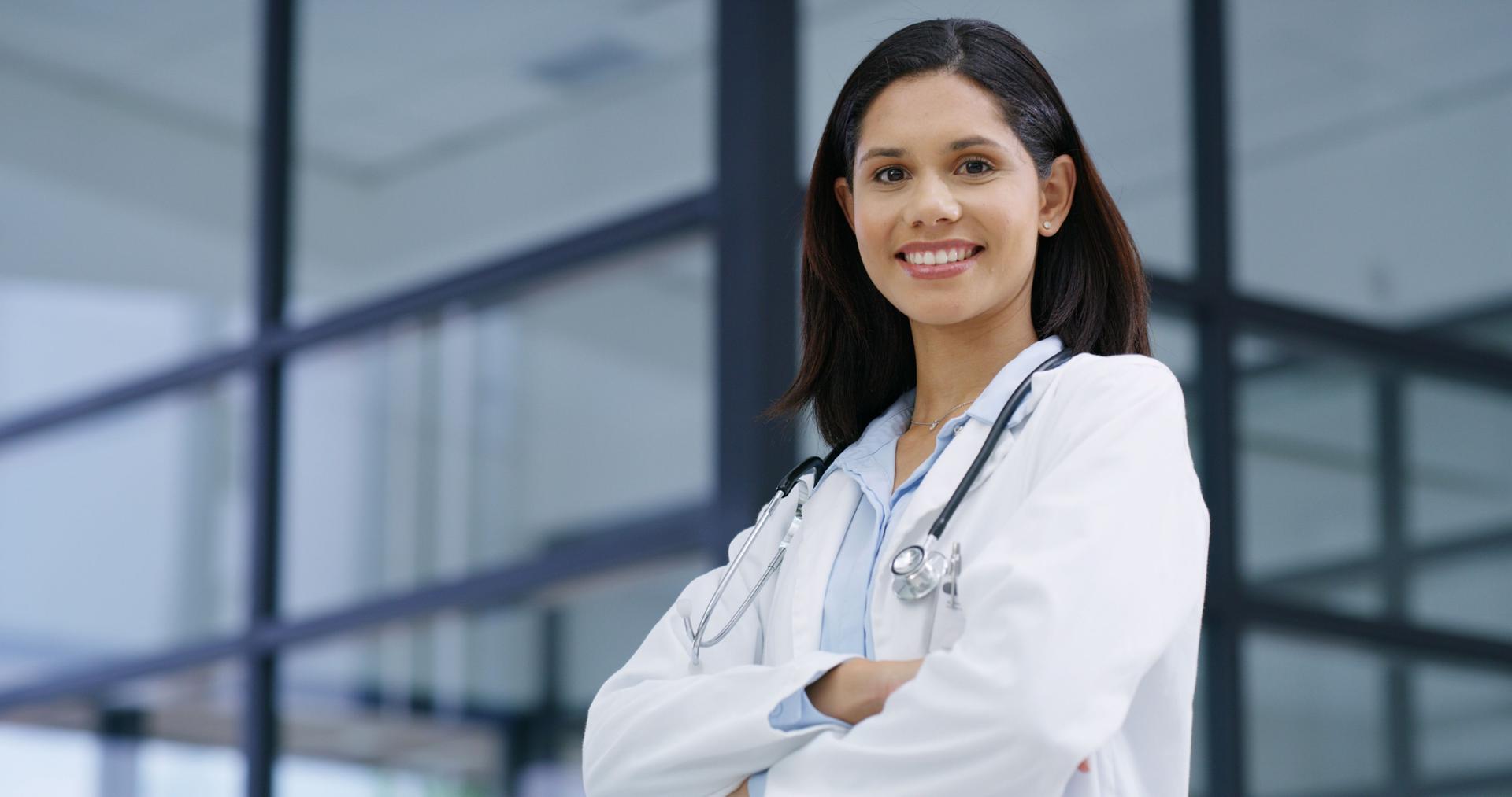 Healthcare, doctor and woman with arms crossed in portrait, medical support and professional career. Hospital, female person and surgeon with smile for confidence, wellness service and about us pride